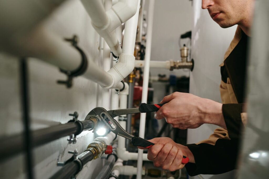 Plumbers maintaining commercial plumbing pipes in Carlisle