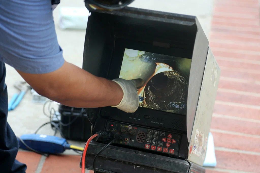 Technician viewing a drain inspection camera in Carlisle