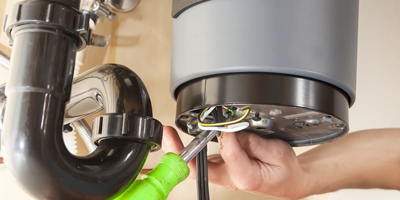 Technician repairing the heating element of a water heater in Carlisle